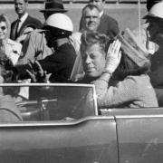 President John F. Kennedy and First Lady Jacqueline Kennedy in their open-top motorcade in Dallas, Texas on November 22, 1963