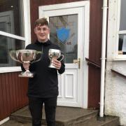 Niall Gallacher with the Club Championship and Cumbrae Cup Trophies