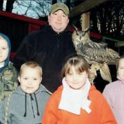 Bird's eye view: Kelburn Country Centre opened a new bird of prey centre to give kids and visitors a rare insight into the world of the interesting species. Pictured here is ranger Alan Jenkins with Walley the European Eagle Owl and some young visitors.