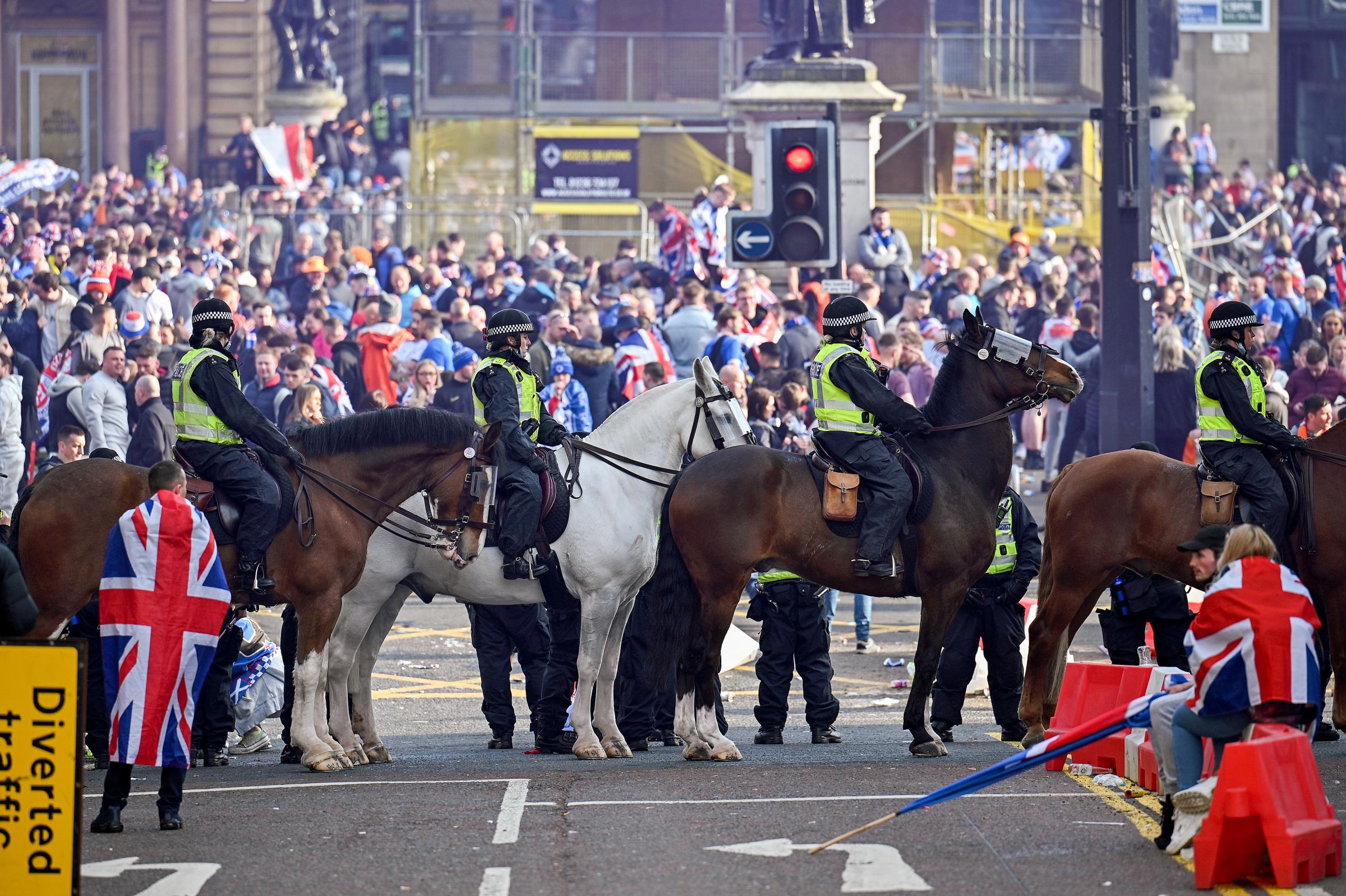 Mounted police look on as Rangers fans gather in Glasgow city centre on Saturday