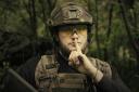 A Ukrainian soldier poses for the camera with his fingers to his lips (Ukrainian Defence Ministry via AP)