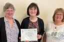 Patricia Gibson receives the award from the Ayrshire WASPI Group