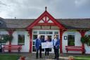 Colin and Robert from Ayrshire Bowling Association present the cheque Elaine Thomson of the Ayrshire Hospice