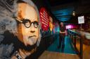 Sign painter Michael Scott pictured in The Glee Comedy Club, Glasgow where he has painted a mural depicting comedy greats.  In this photograph Billy Connolly, Kevin Bridges, Frankie Boyle and Bob Hope and is in the process of completing a mural of Laurel