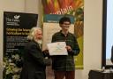 Caleb is presented with his prestigious certificate at awards ceremony