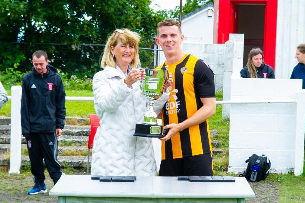 Largs and Millport Weekly News: Stuart Faulds captain of Largs Thistle being presented the John Grant Memorial Trophy by Anne Grant widow and Director of JW Grant Builder Merchants 
