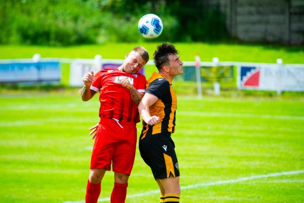 Largs and Millport Weekly News: Heads up - Alan Frizzell in action on his debut versus Maryhill. Photo - Ryan Scott Photography