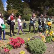 Watering cans at the ready! Academy pupils with Caroline Le Good Morgan of Douglas Park project