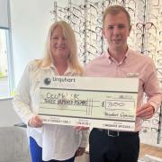 Kathleen pictured with Neil Gray at Urquhart Opticians in West Kilbride after the firm donated £300 to the West Kilbride woman's fund-raiser in aid of the charity OcuMel