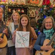 David and Irene with Hayley Strain and her winning poster along with Donna from the Christmas Shop