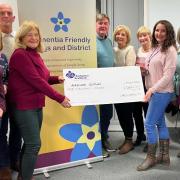 The Largs Dementia Friendly group presents a cheque for £1,000 to Linda Ross of Alzheimer Scotland