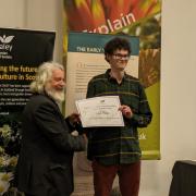 Caleb is presented with his prestigious certificate at awards ceremony
