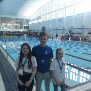 Picture: L – R Rachel McGuire, Fraser Kelly, Isla Waller with their medals